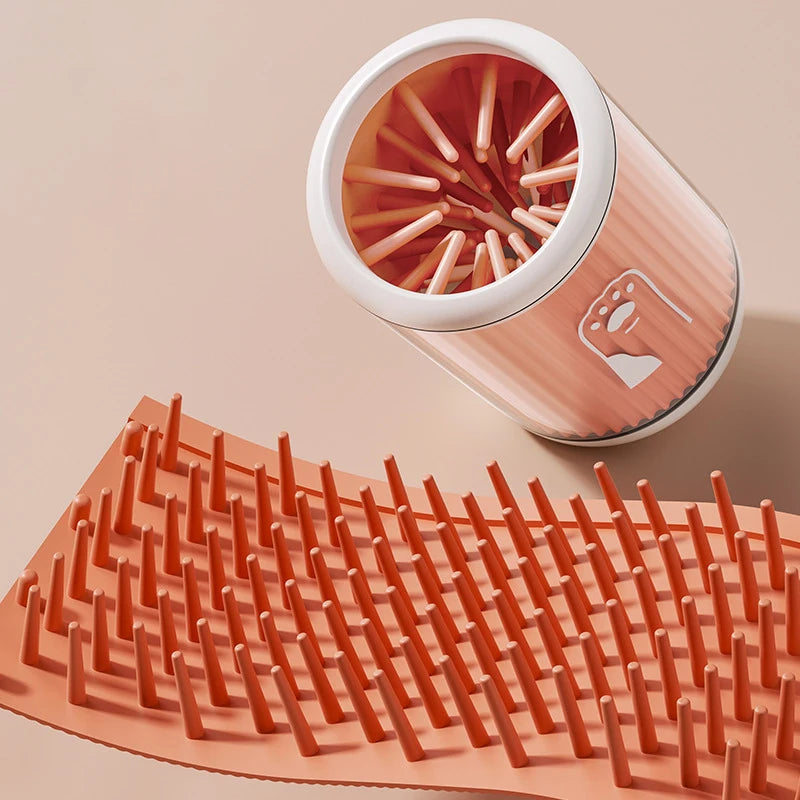 dog paw cleaner cup in green, orange and blue on clean modern background