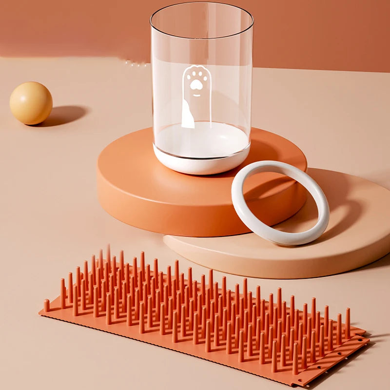 dog paw cleaner cup in green, orange and blue on clean modern background