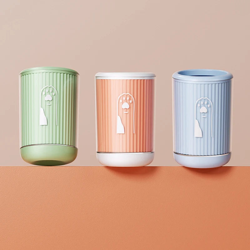 dog paw cleaner cup in green, orange and blue on clean modern background