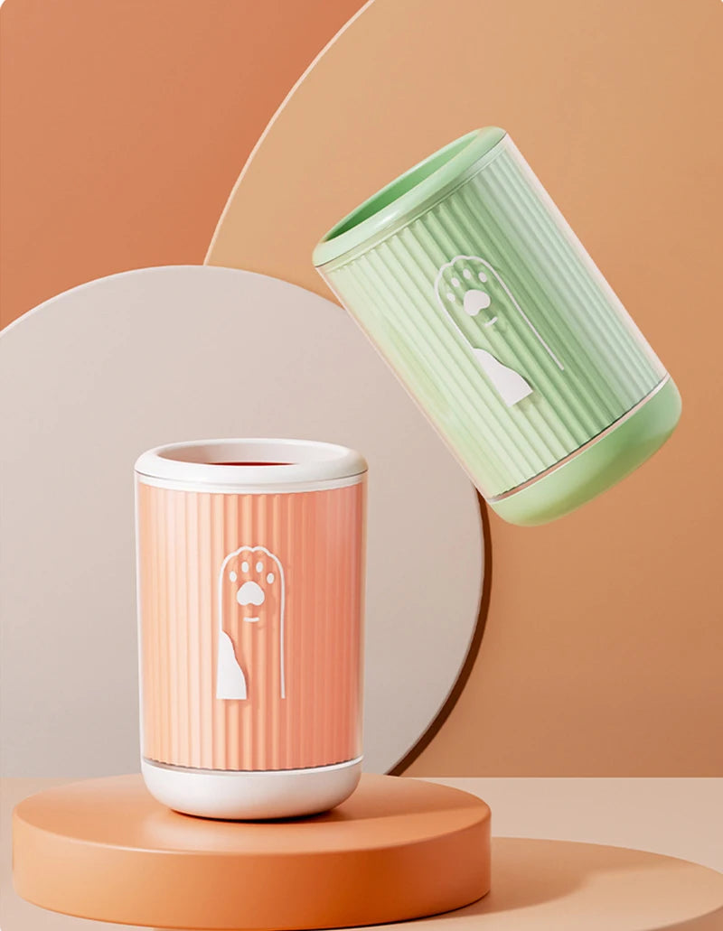 dog paw cleaner cup in green, orange and blue on clean modern background